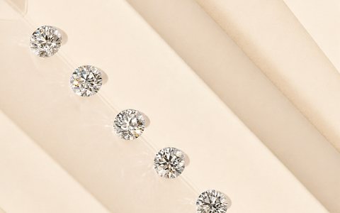 Loose round diamonds arranged for inspection on a neutral surface.